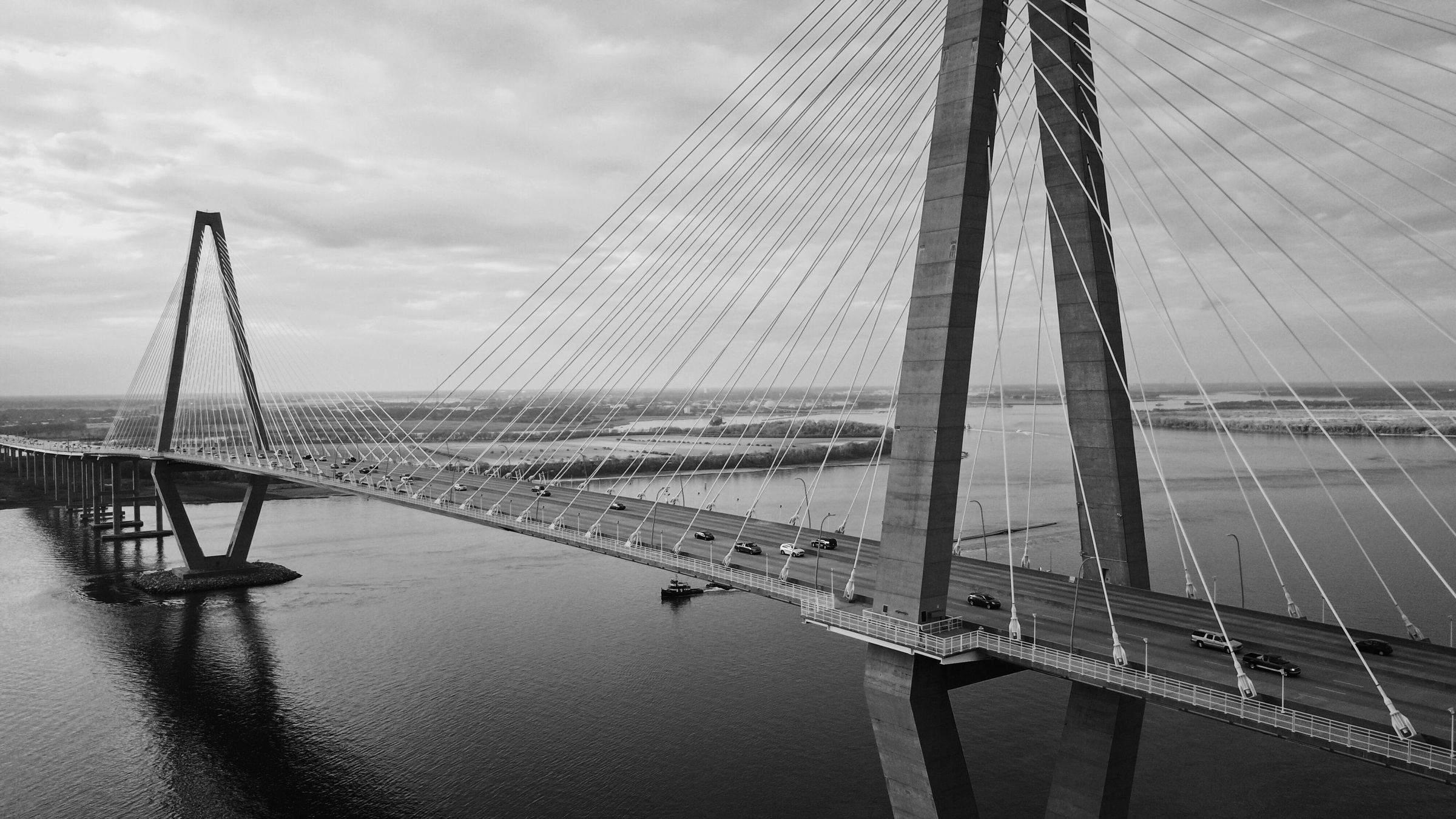 Aerial view of a cable-stayed bridge crossing open water