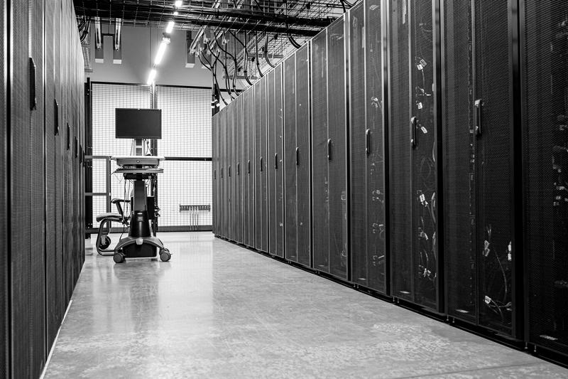 An aisle of server cabinets in a data centre