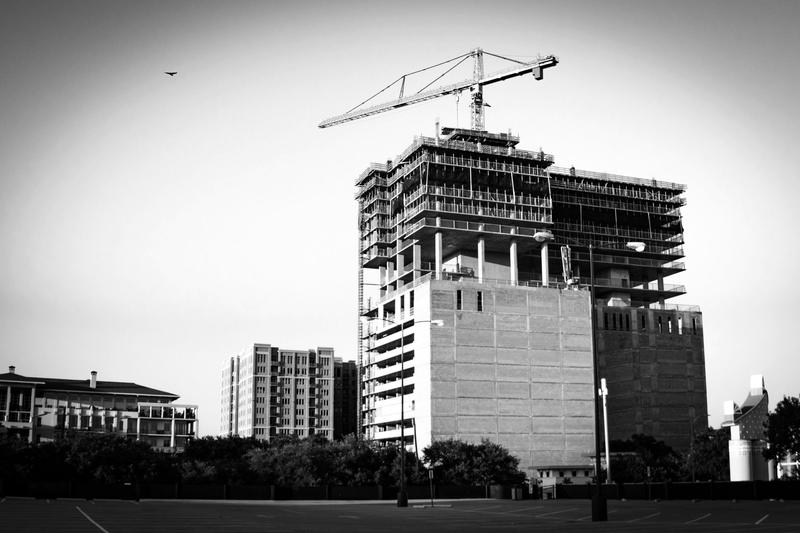 A tower under construction with a crane on top