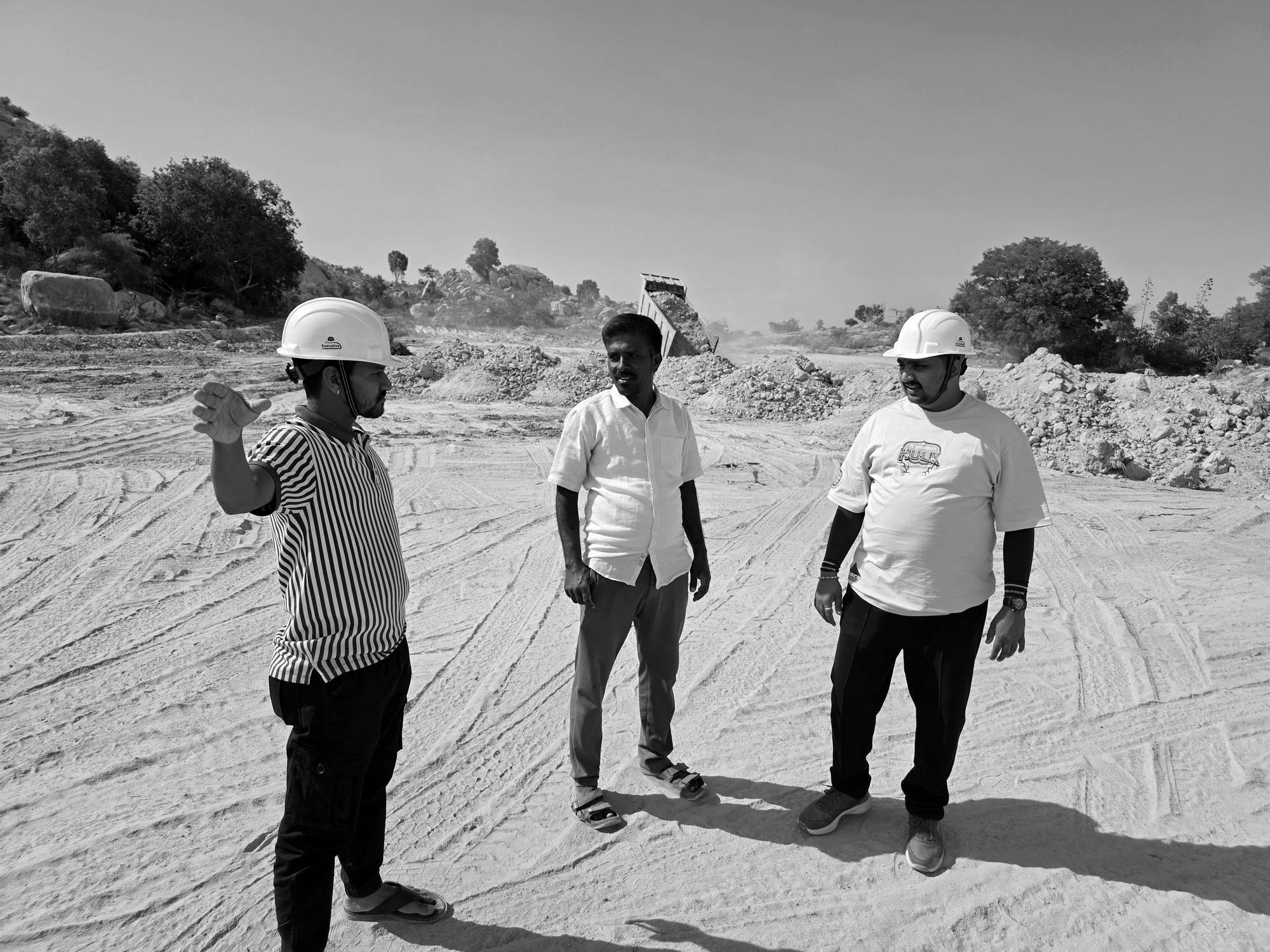 A project team walking a cleared building site