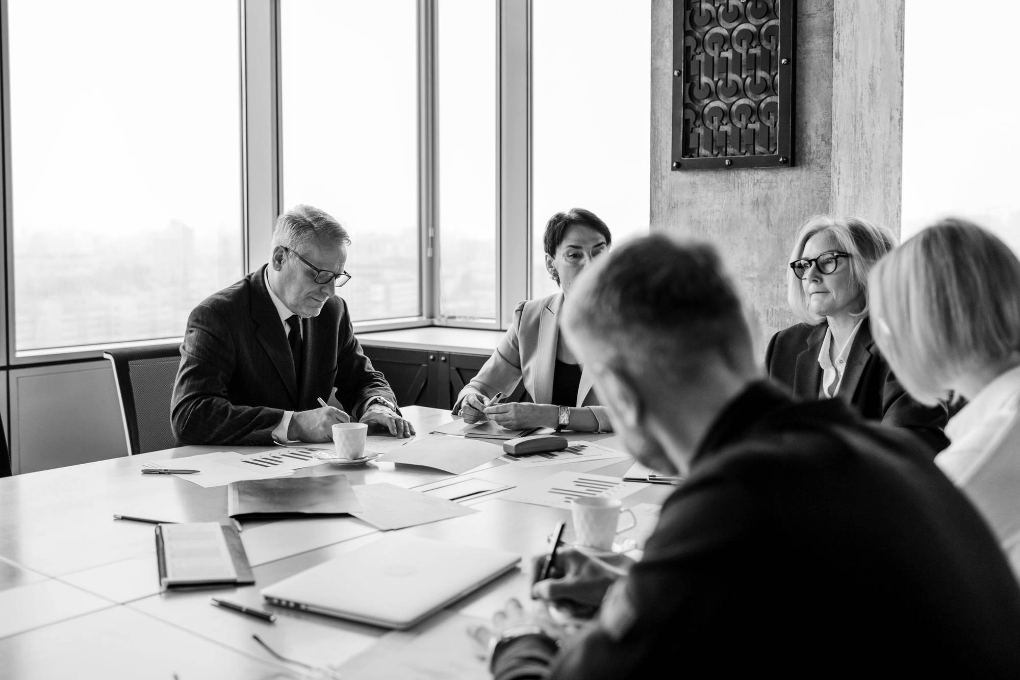Senior executives reviewing papers around a boardroom table