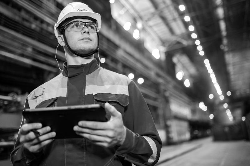 An engineer with a tablet in a steel works