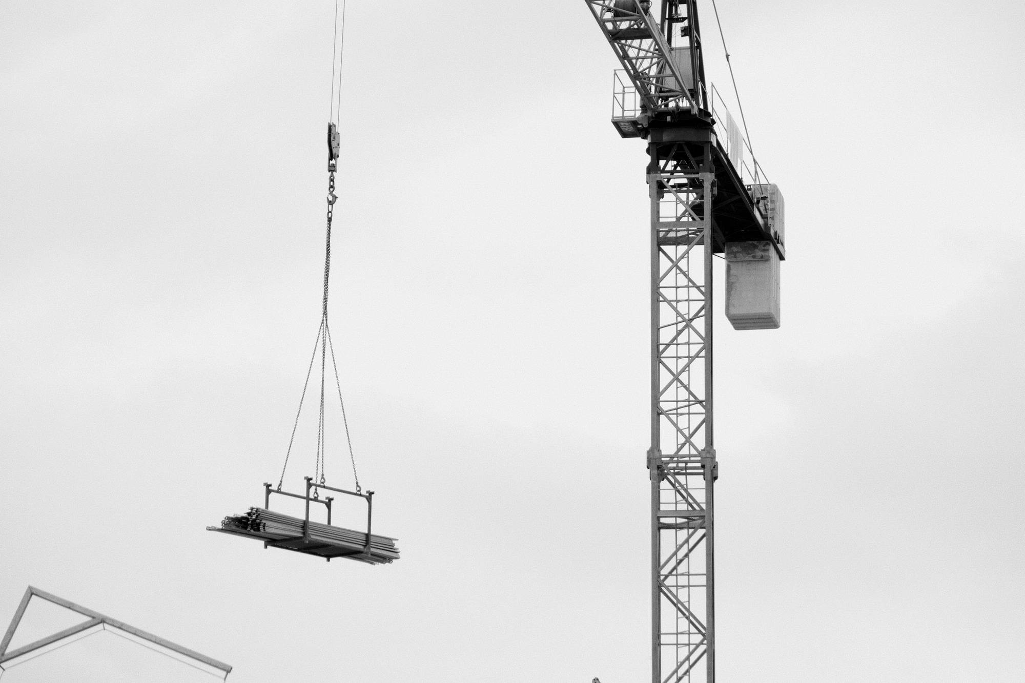 A tower crane lifting a load into place