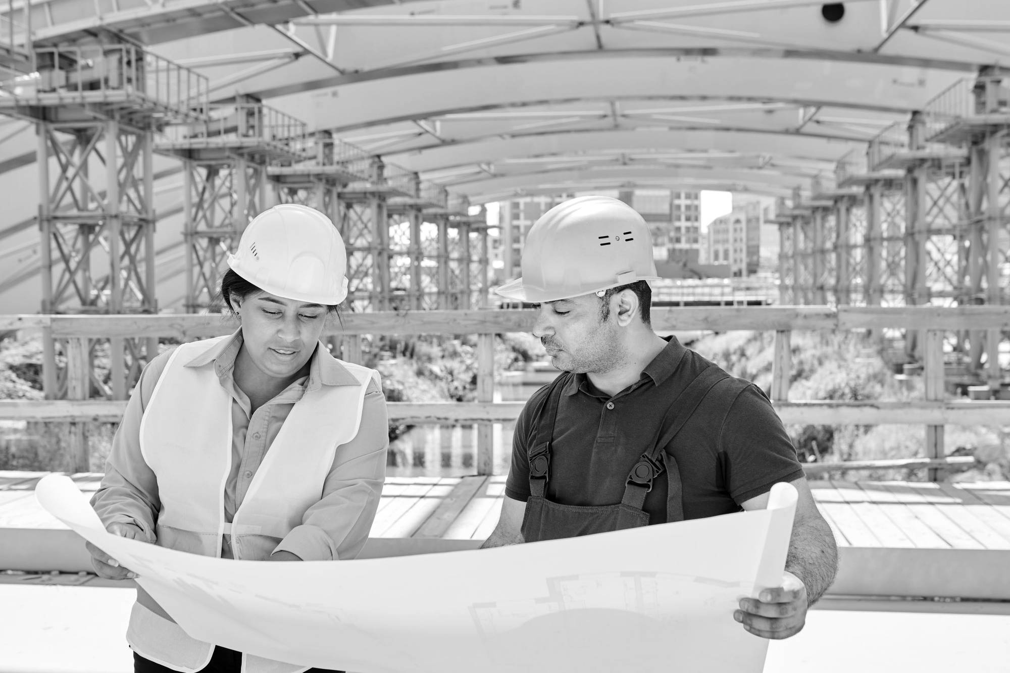 Two engineers reviewing a plan on a construction site